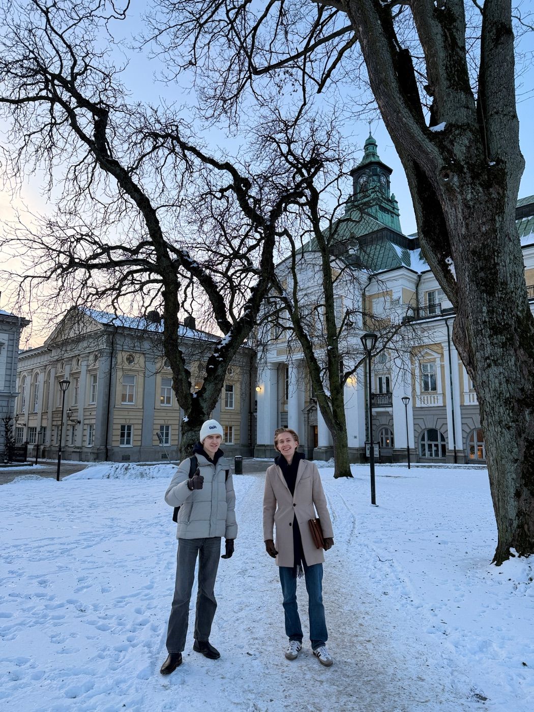 Two of the Gradr team outside a school on a winter morning